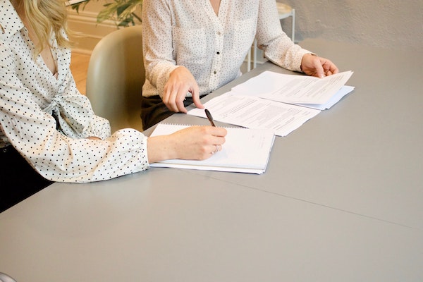 Two women reviewing paperwork